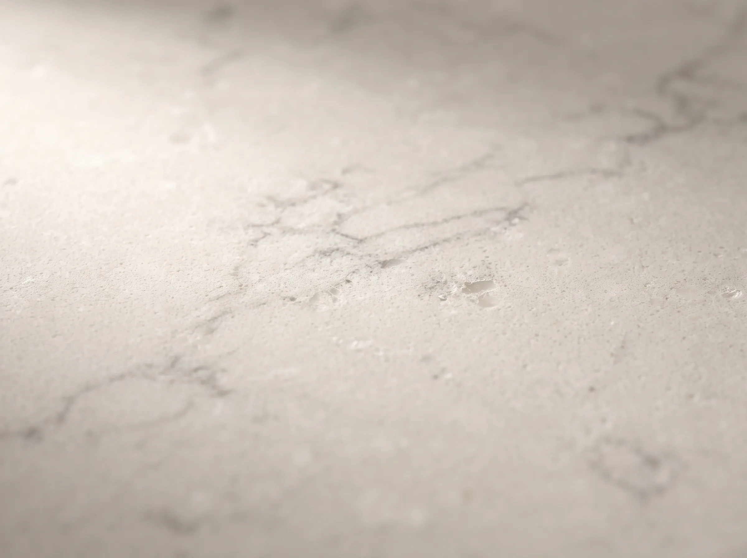 Honed quartz material macro, soft veined off-white stone